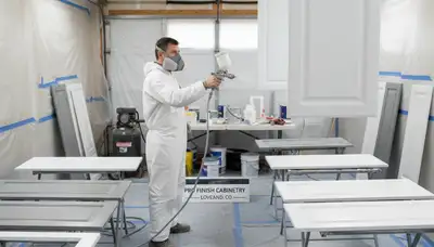 Professional cabinet painting in Loveland, CO using spray and brush techniques for smooth kitchen finishes